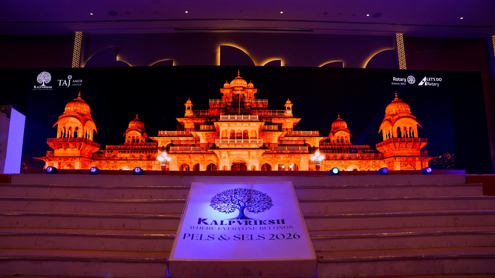 Panoramic LED wall displaying architectural content on a conference stage
