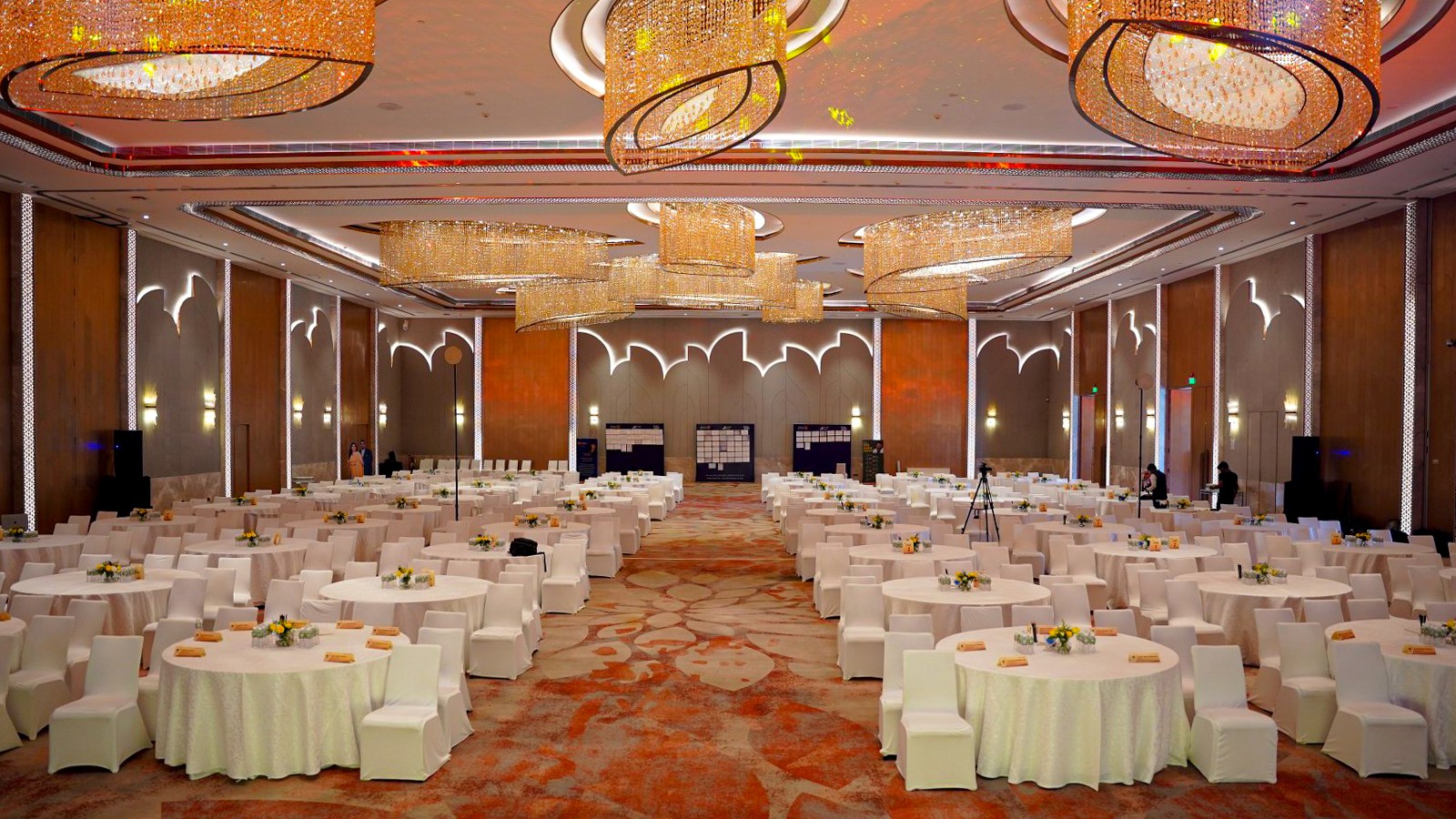 Bright corporate ballroom prepared with symmetrical banquet seating